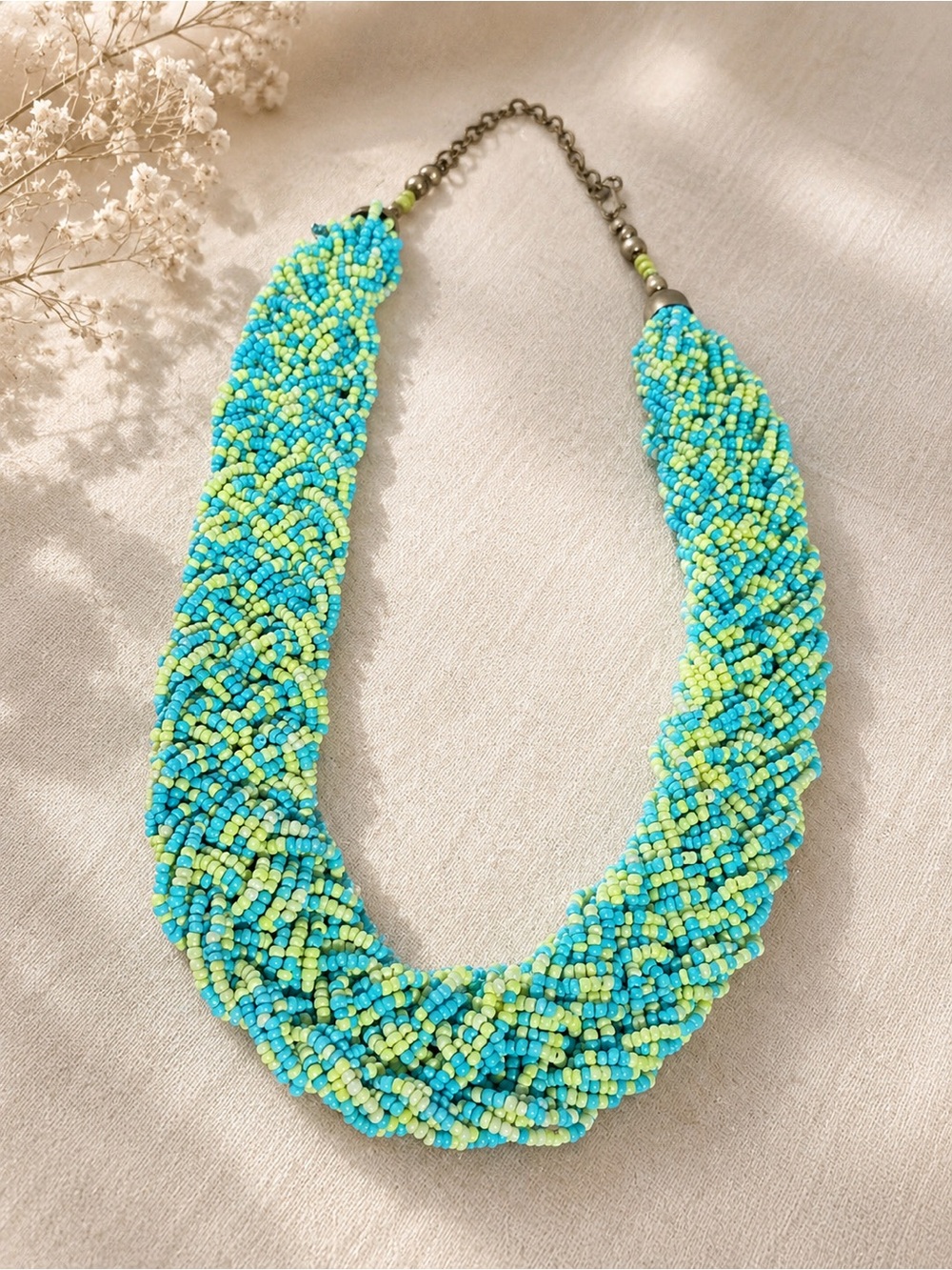 Chunky multi-strand seed bead necklace in turquoise and lime green.